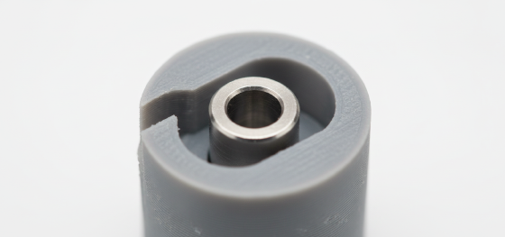 Perfectly round steel shaft sitting loosely inside an oval shaped 3D printed hole causing dimensional failure