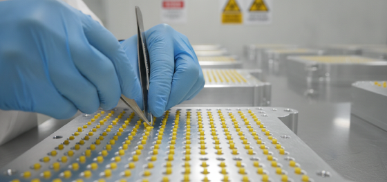 Technician inserting tiny silicone rubber plugs into threaded holes to protect against caustic acids