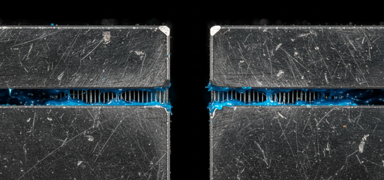 Exhausted P20 tool steel parting line choked with hardened blue polymer resin inside air vents